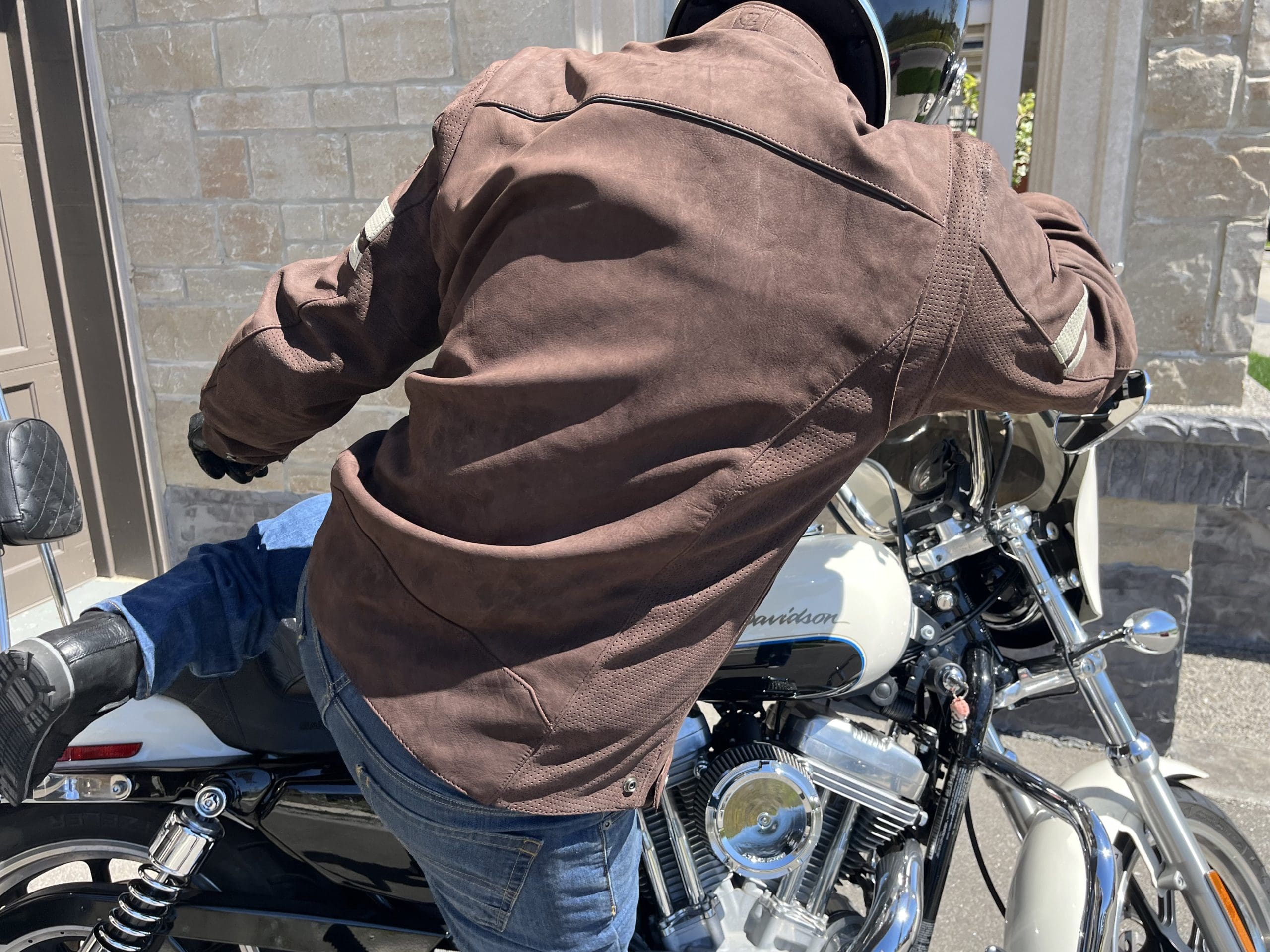 motorcycle rider getting on harley davidson while wearing Joe Rocket Classic 92 Leather Jacket