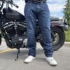 Rider wearing the K Forty 2 Stretch Denim Jeans in front of a black Harley Davidson