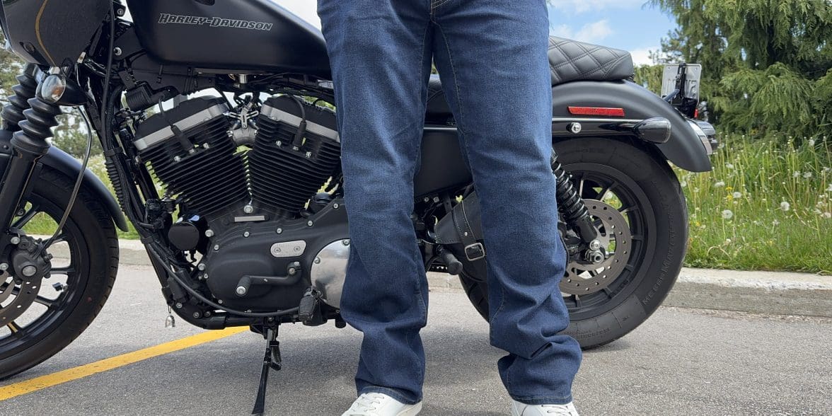 Rider wearing the K Forty 2 Stretch Denim Jeans in front of a black Harley Davidson