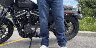 Rider wearing the K Forty 2 Stretch Denim Jeans in front of a black Harley Davidson