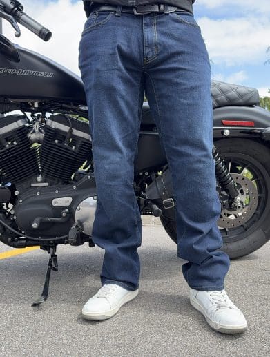 Rider wearing the K Forty 2 Stretch Denim Jeans in front of a black Harley Davidson