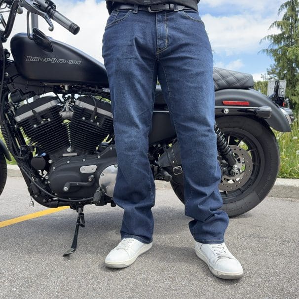 Rider wearing the K Forty 2 Stretch Denim Jeans in front of a black Harley Davidson