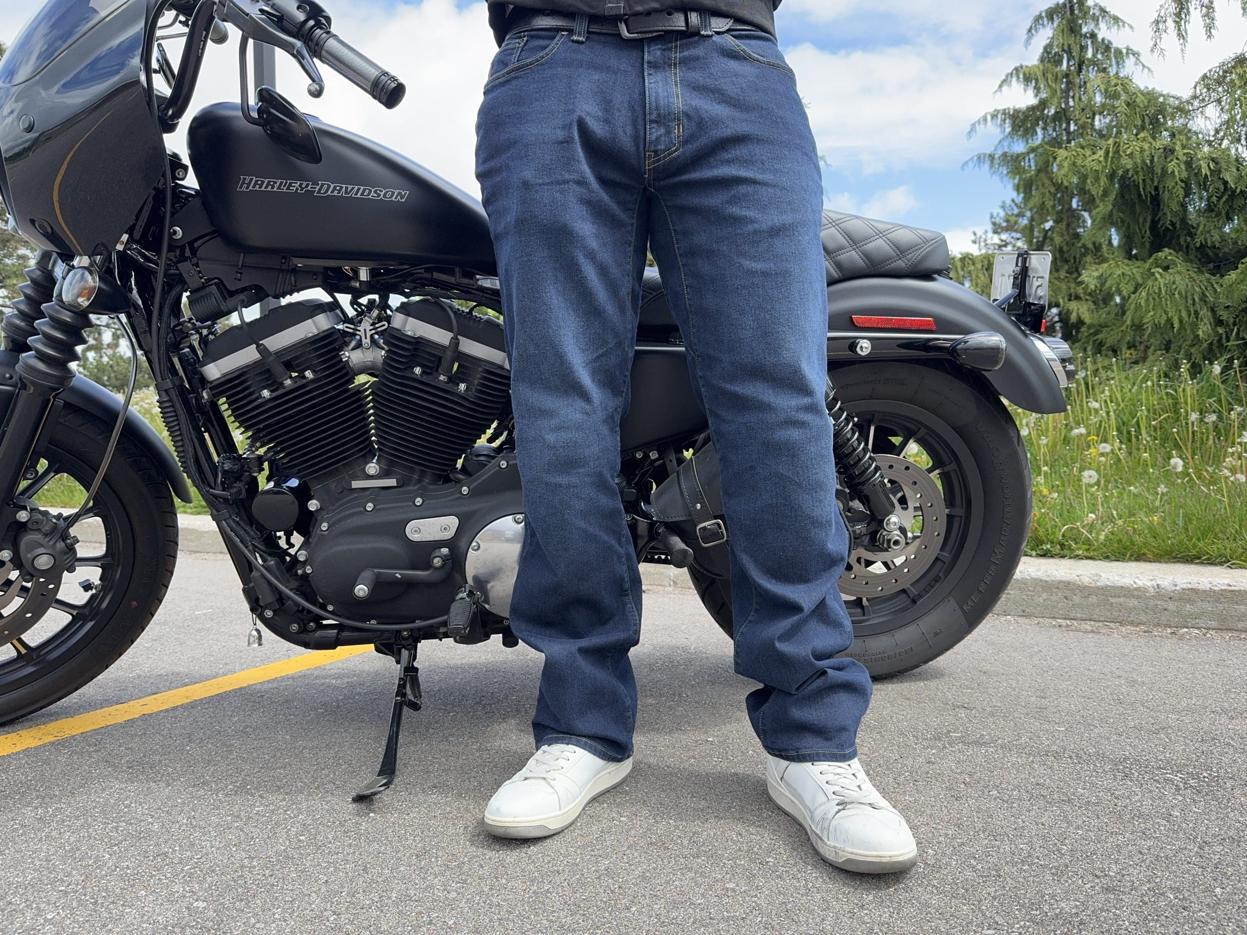 Rider wearing the K Forty 2 Stretch Denim Jeans in front of a black Harley Davidson