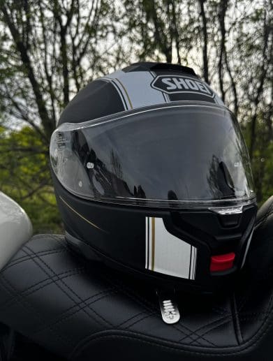 Shoei Neotec 3 Satori TC-5 Helmet resting on saddlemen seat of harley davidson sportster 883