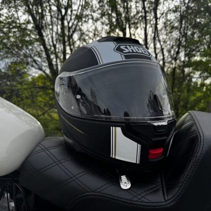 Shoei Neotec 3 Satori TC-5 Helmet resting on saddlemen seat of harley davidson sportster 883
