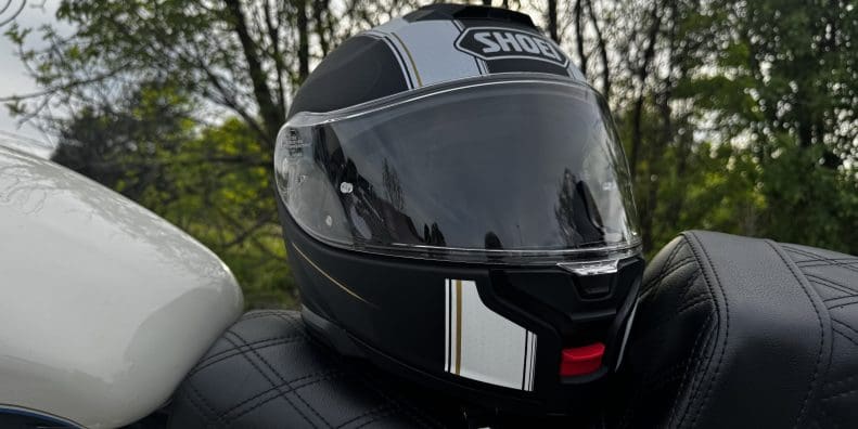 Shoei Neotec 3 Satori TC-5 Helmet resting on saddlemen seat of harley davidson sportster 883