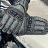 TOURMASTER Super Warm Waterproof Gloves resting on eachother on top of harley davidson tank.