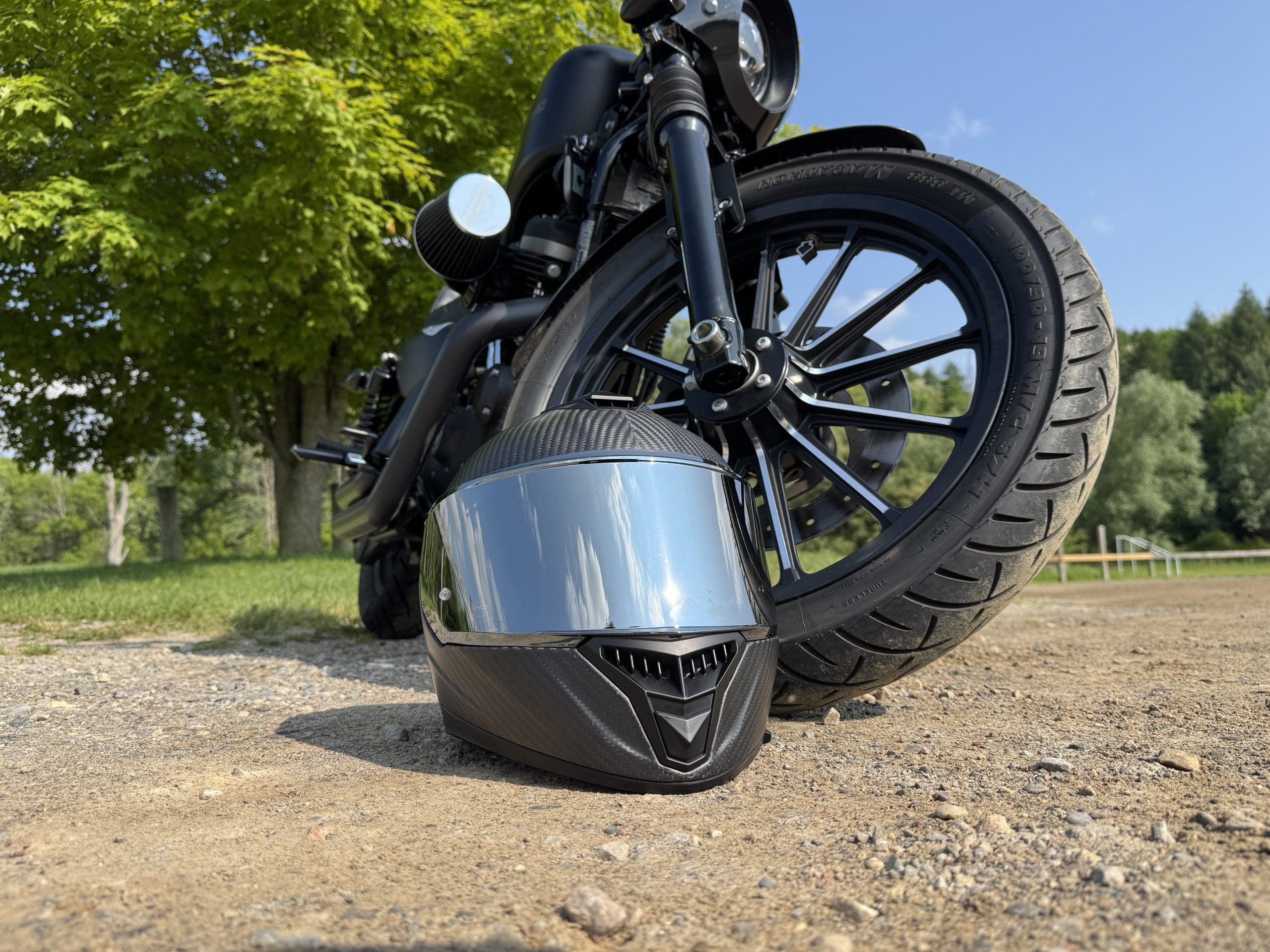 Voss 991 Carbon helmet next to a Harley Davidson tire