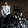 A view of a man atop a Norton motorcycle.