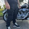 Pando Moto Desert Cargo pants standing beside motorcycle