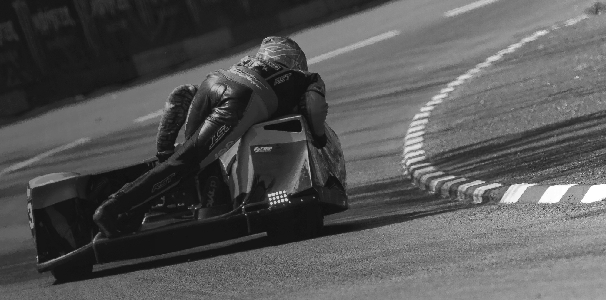 A view of a sidecar racing duo making a turn on Isle of Man's Mountain Course. Media sourced from Isle of Man TT Races.