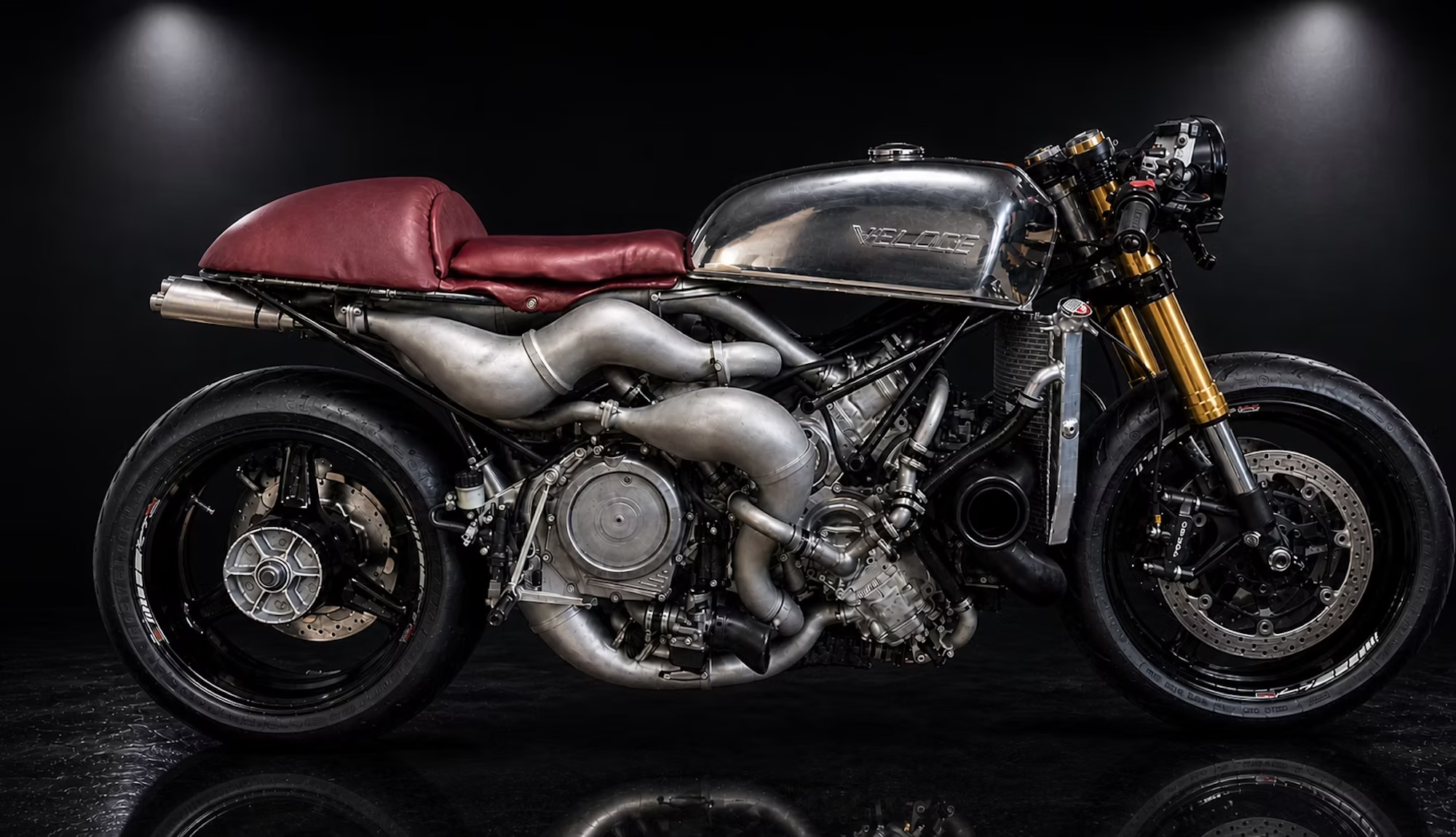 A dynamic side view of the Veloce Apron - a super bike with an insane X formation engine platform.